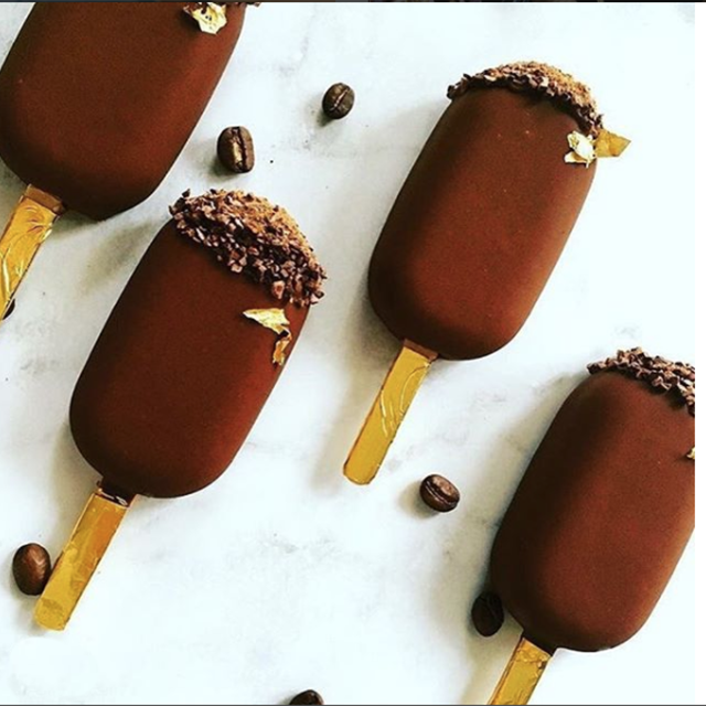 Real photograph of four CCC vegan chocolate ice creams on sticks