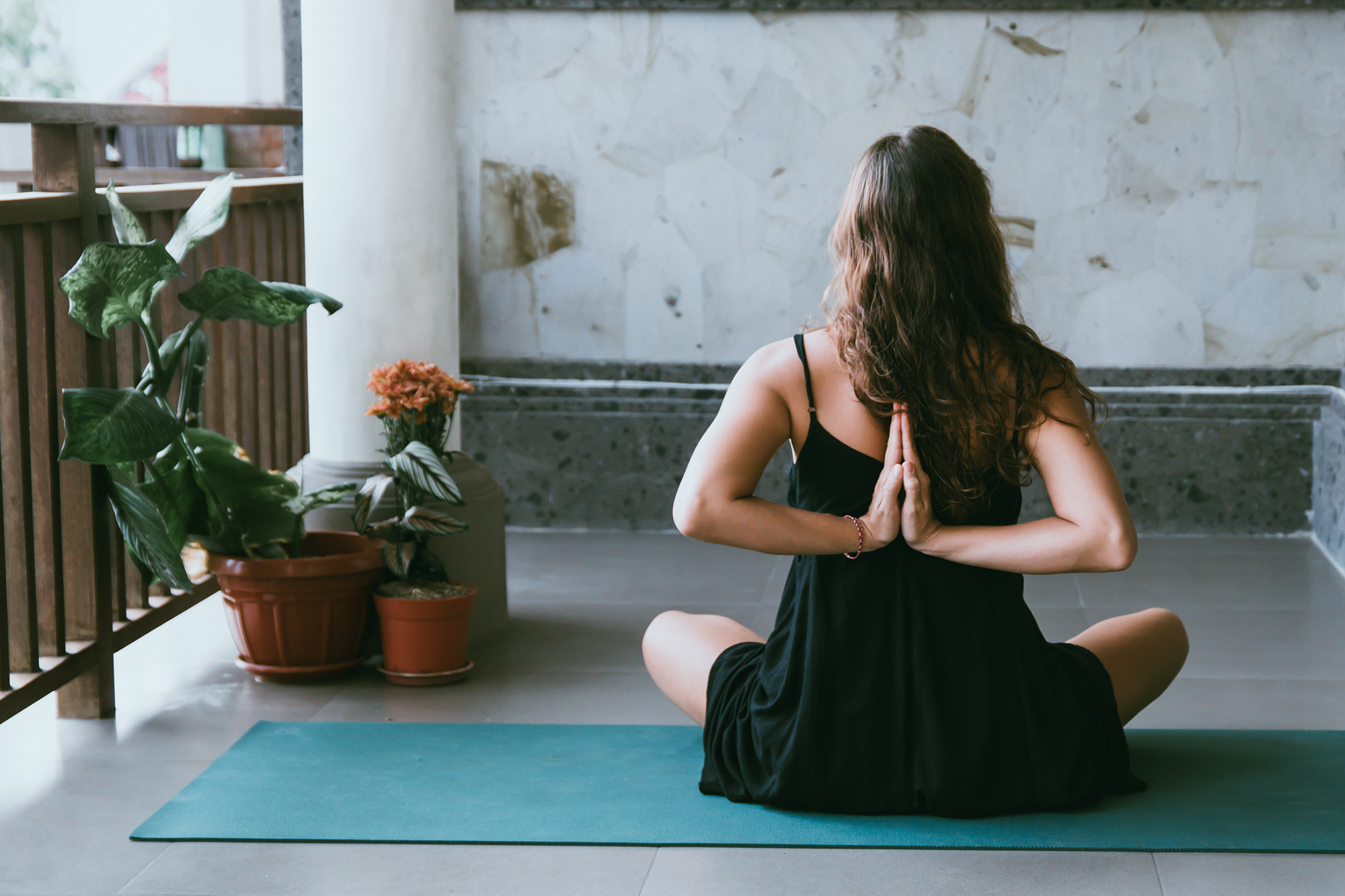 Image of woman in yoga pose with arms behind her back