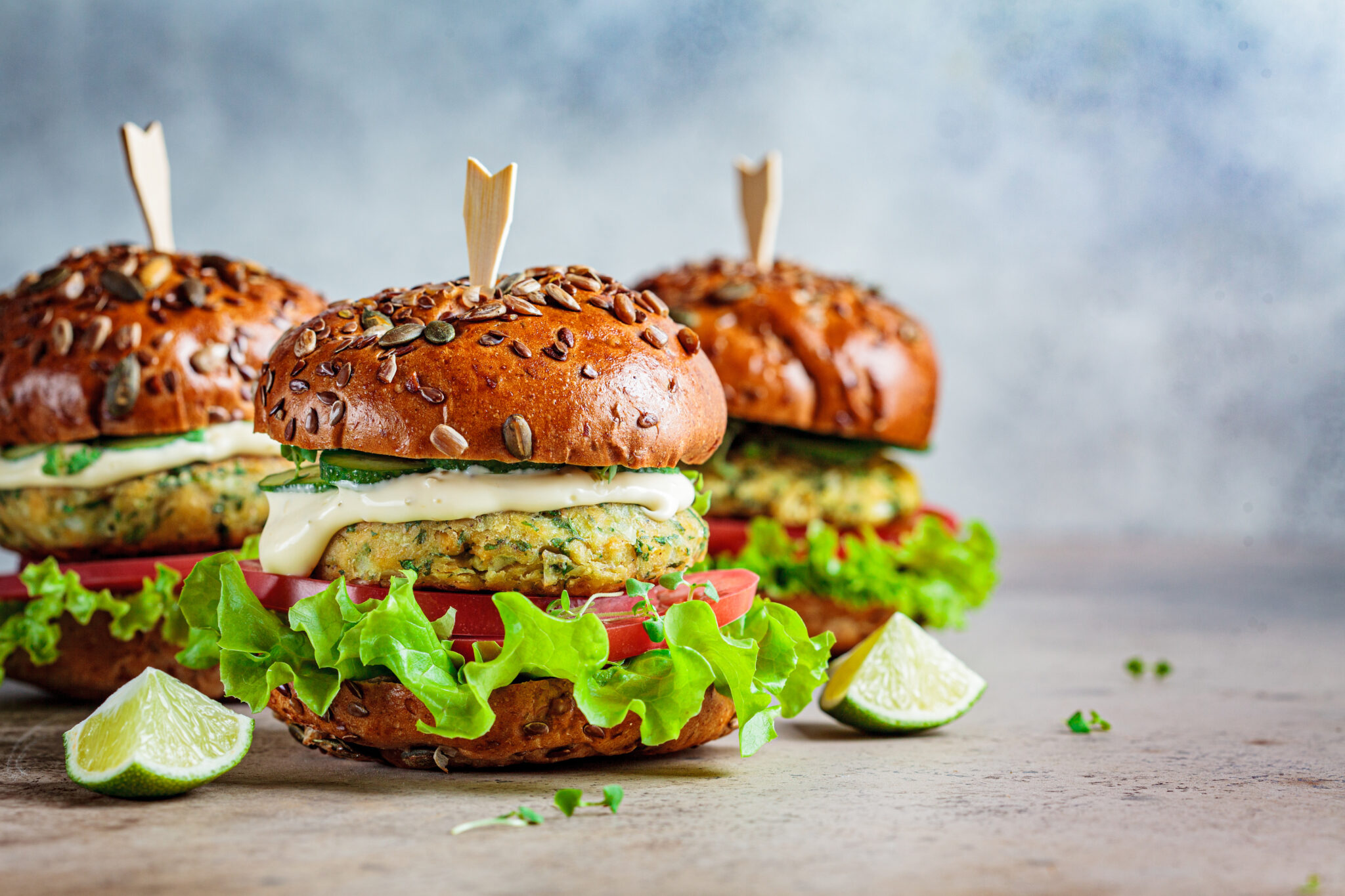 Image features: Vegan falafel burgers with vegetables and sauce. Plant-based food concept.