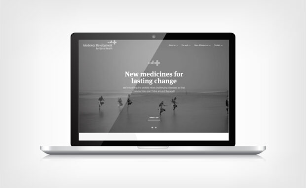 MDGH featured image - mockup of above the fold home page on a laptop screen in greyscale