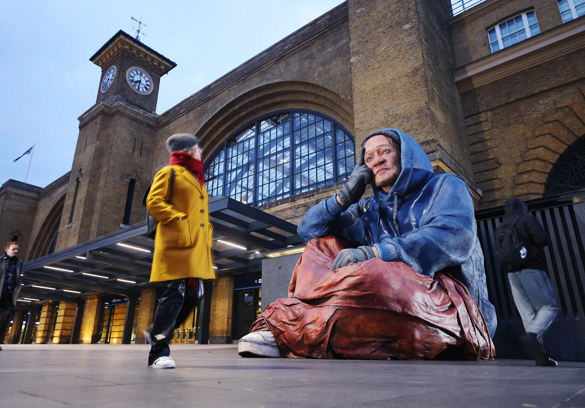 Photograph of sculpture titled 'Alex' (2022) - a 14ft hyper-real homeless sculpture unveiled in Birmingham by Crisis charity.