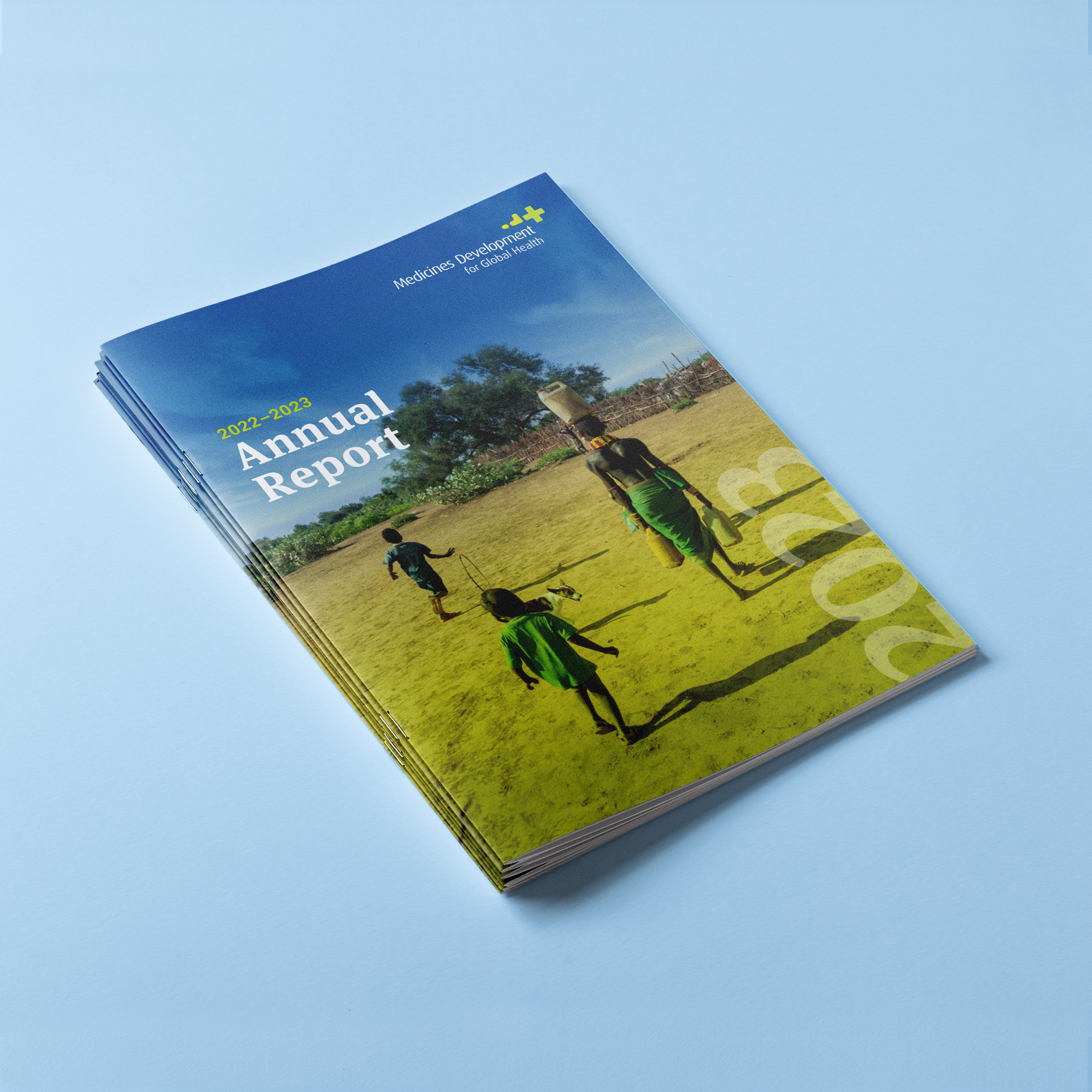 Cover design of the 2022–2023 MDGH Annual Report, designed by EDCo., featuring a vibrant photograph of a rural setting in Africa to emphasise their global health focus.