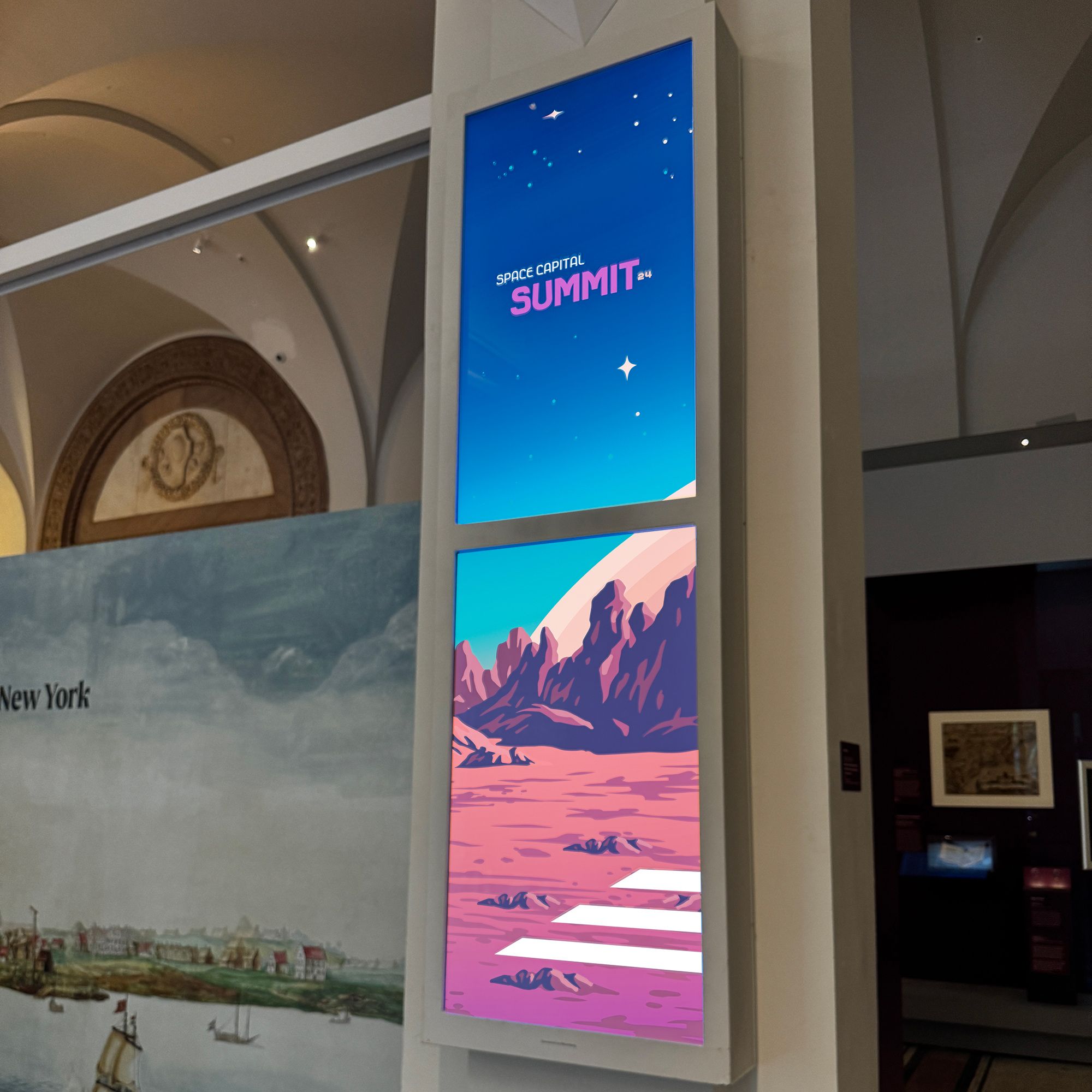 Event branding on lobby pillars at the New York Historical Society for the Space Capital Summit 2024.