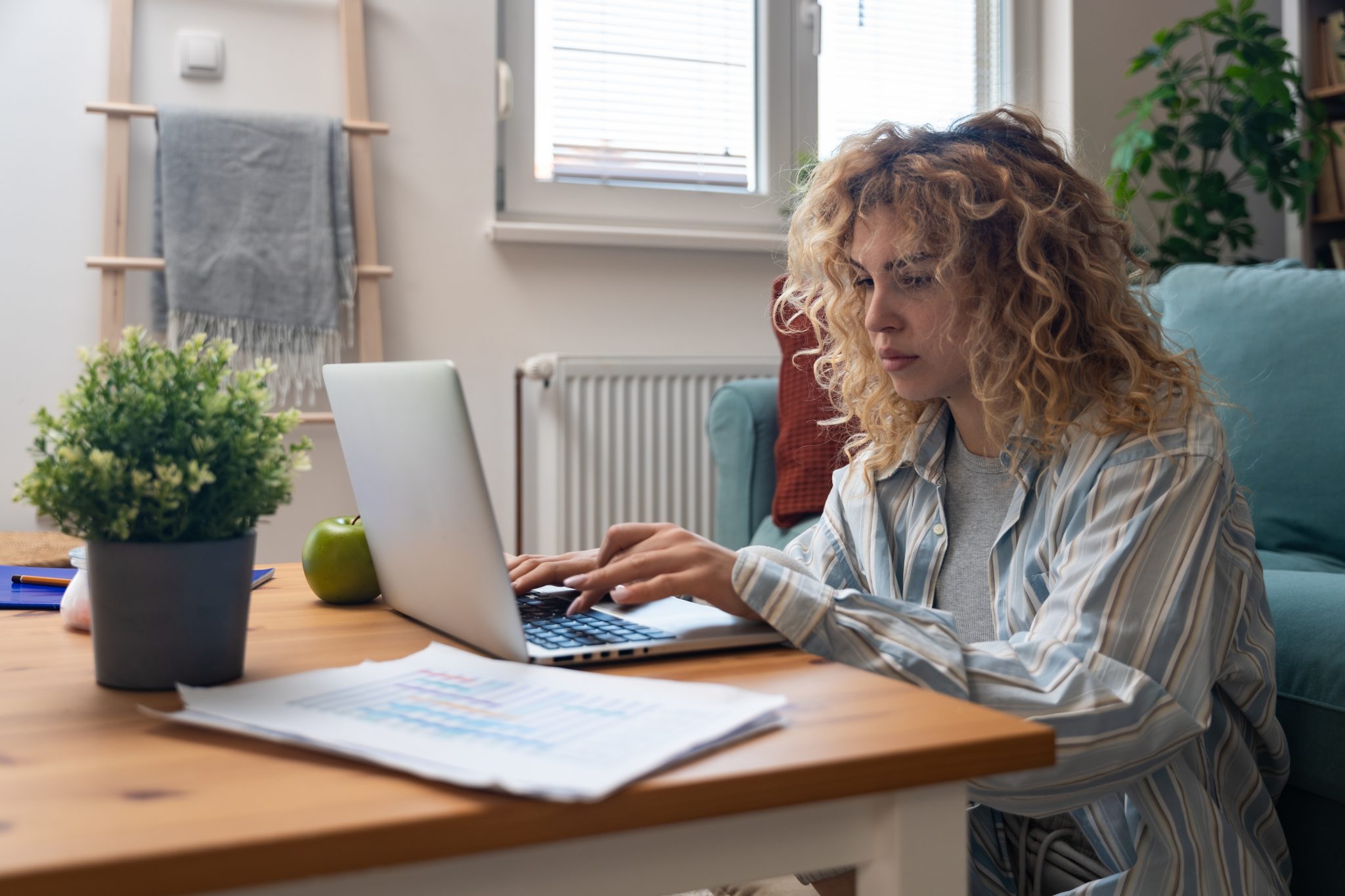 Stressed woman looking at computer screen in a cluttered workspace, representing the overwhelm of digital clutter.
