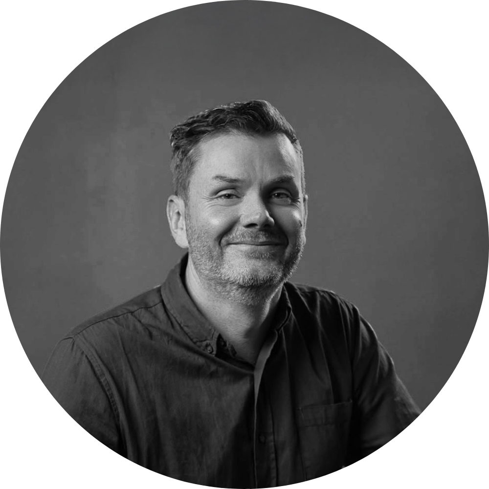 Luke Sharrock headshot - greyscale and circle cropped