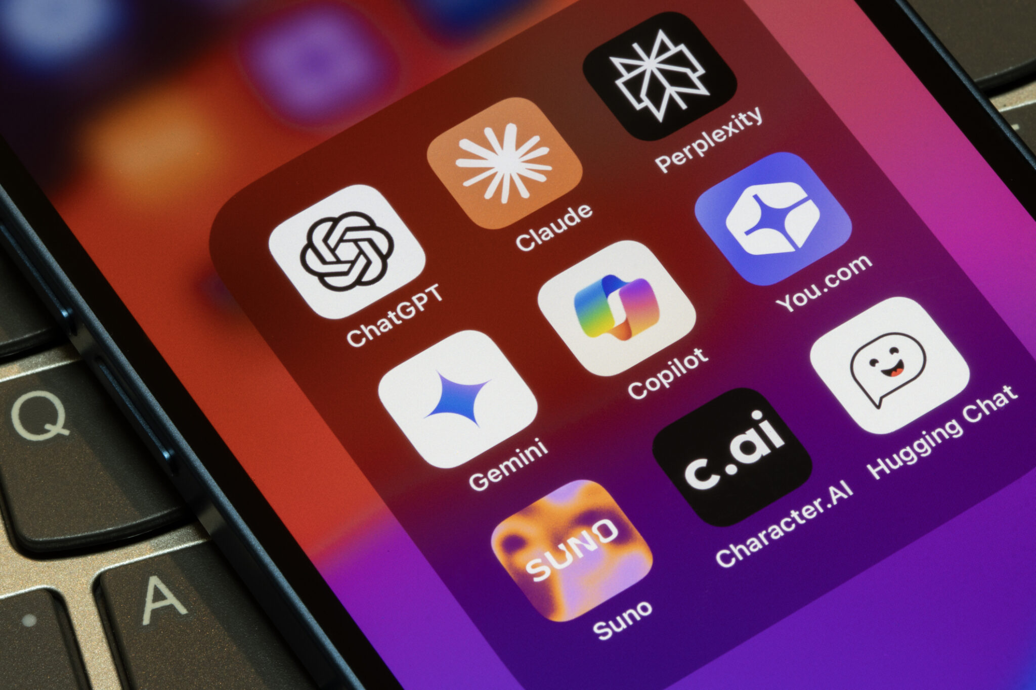 AI app icons on an iPhone, including ChatGPT, Claude, Perplexity, Gemini, Copilot, You.com, Suno, and Character.AI