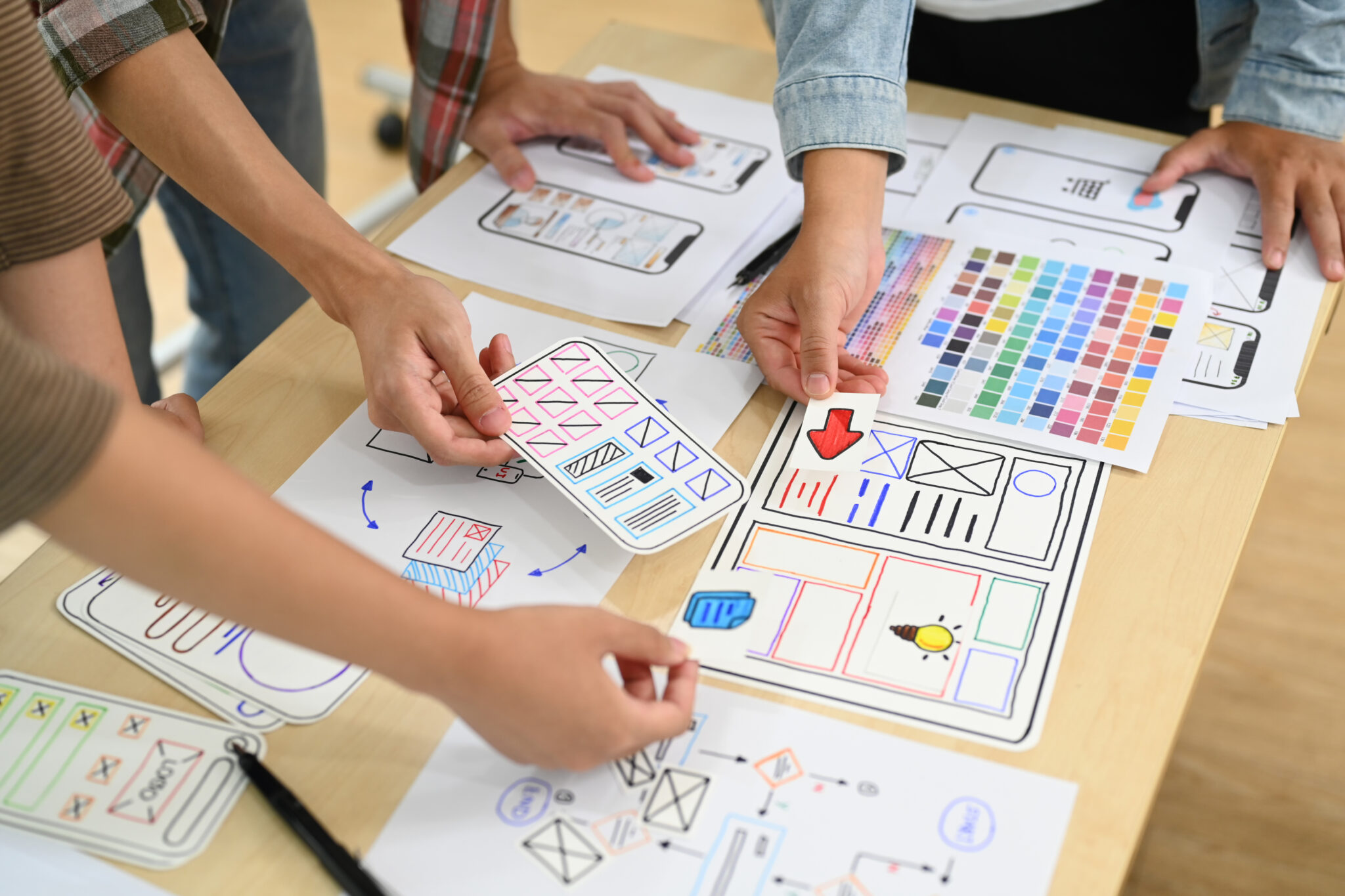 Design team reviewing UX and UI wireframes, representing the importance of human judgement in digital work